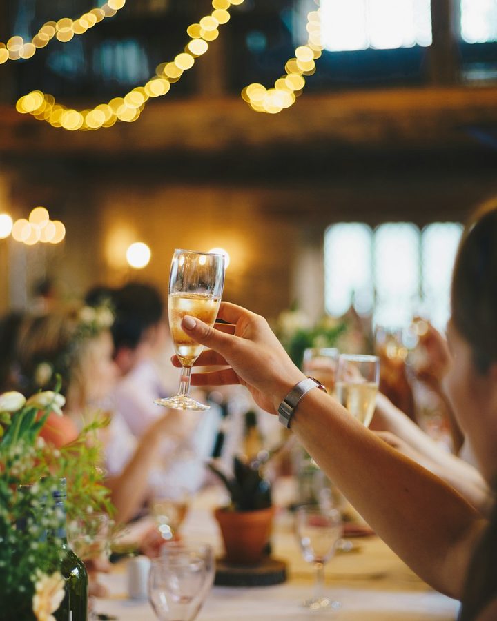 Guests raising glasses at a reception table