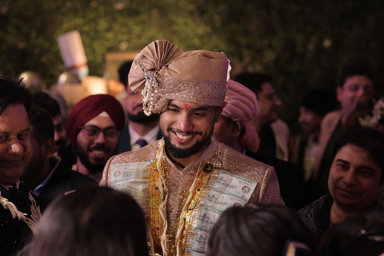 Indian groom celebrating with family and friends