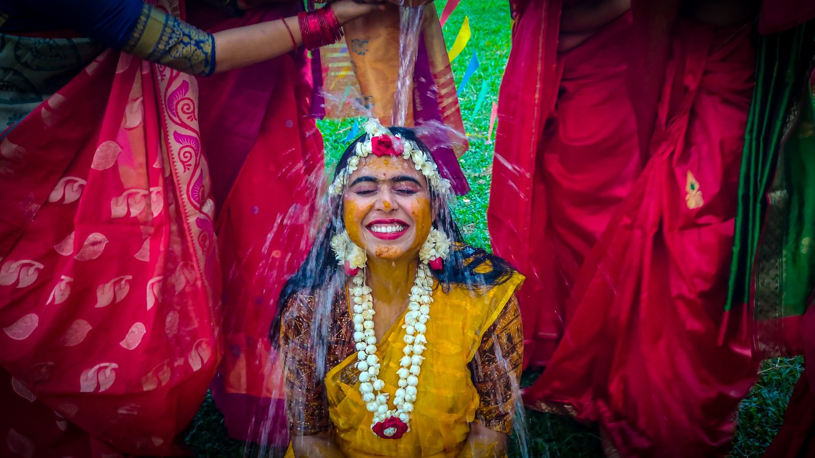 Bride smiling during her vibrant haldi ceremony