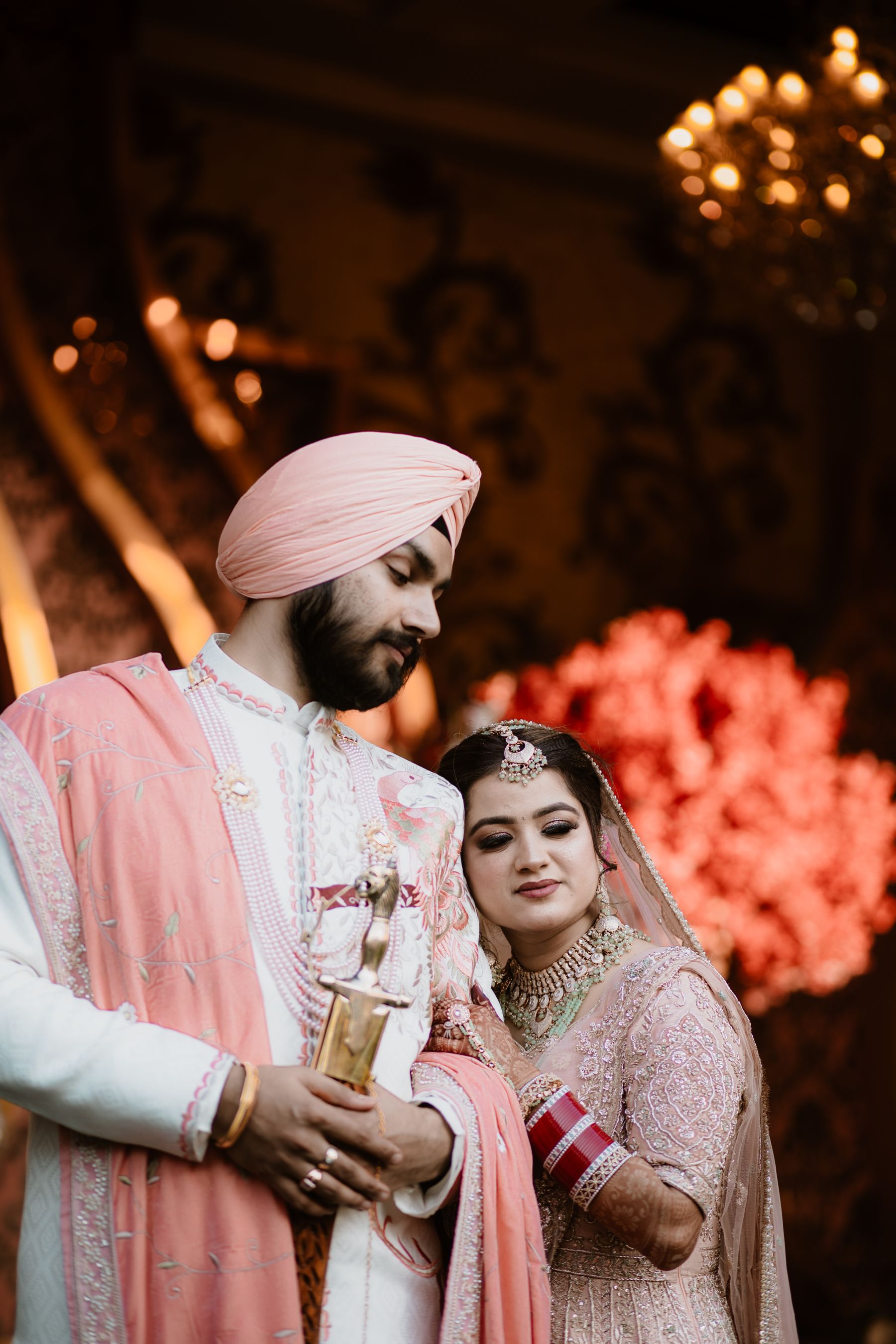 Modern Indian bride and groom in coordinated wedding attire at an evening celebration
